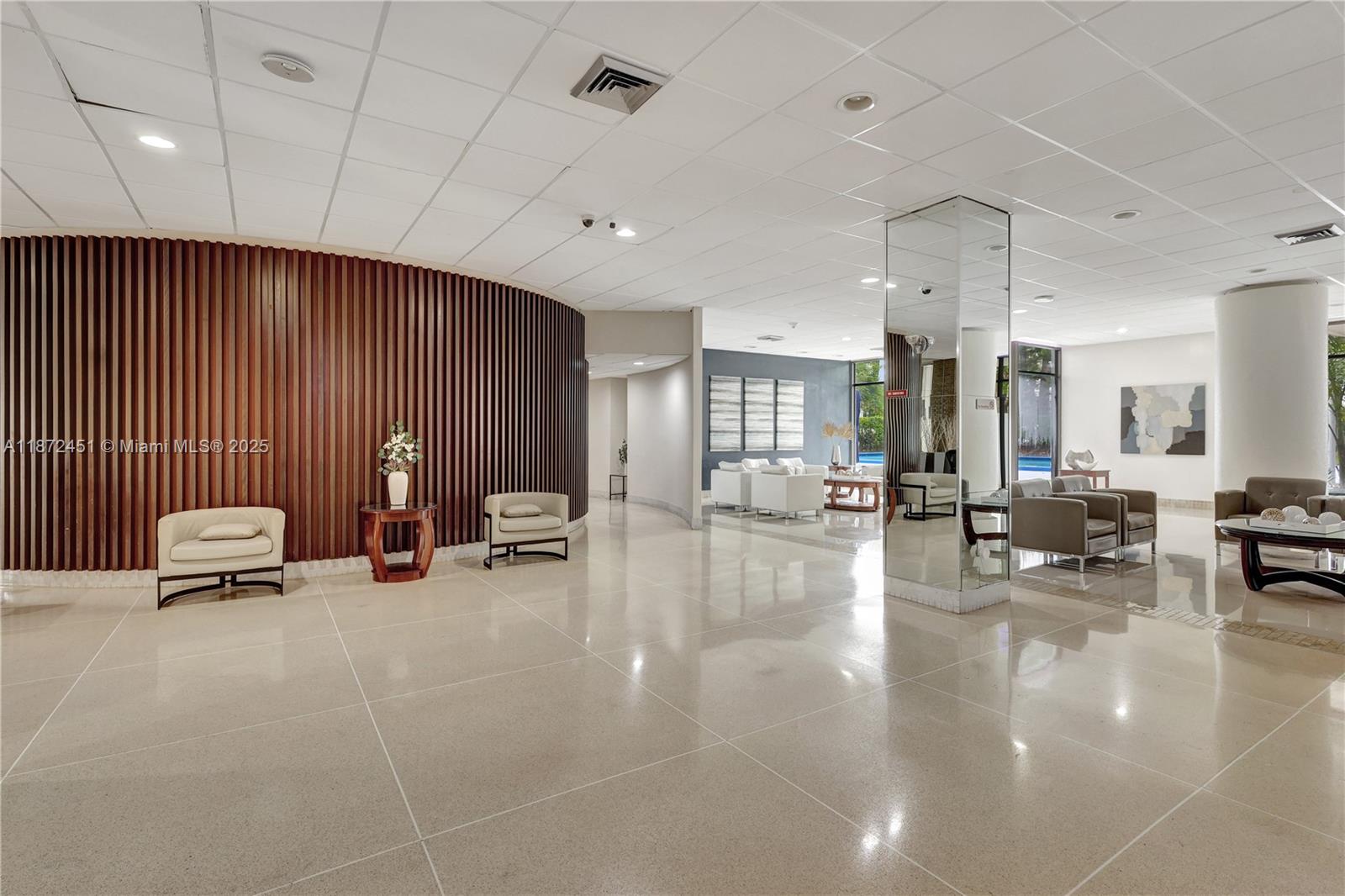 20100 West Country Club Drive, Unit 204 Aventura, FL 33180 - Photo 6 of 25 a living room with furniture and a table