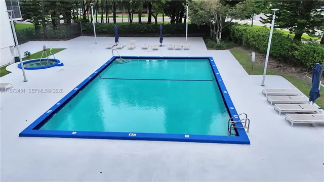 swimming pool view with a outdoor seating