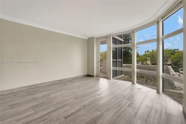 a view of wooden floor and windows in a room