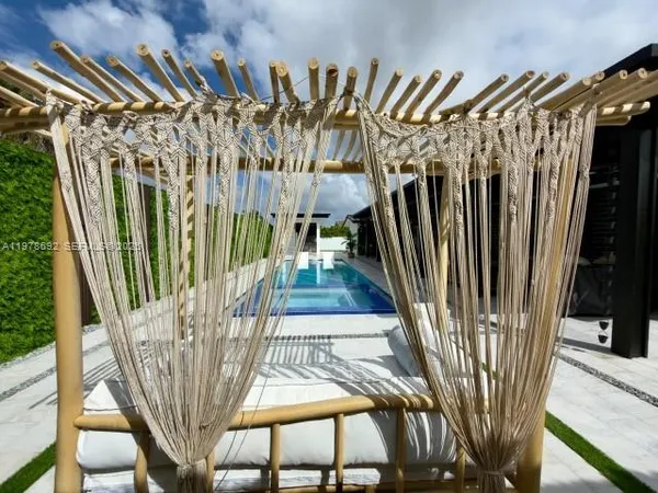 a view of a patio with couches table and chairs and potted plants