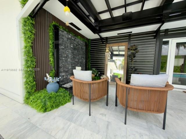 9351 Southwest 88th Terrace Miami, FL 33176 - Photo 19 of 73 a view of a patio with couches table and chairs and potted plants