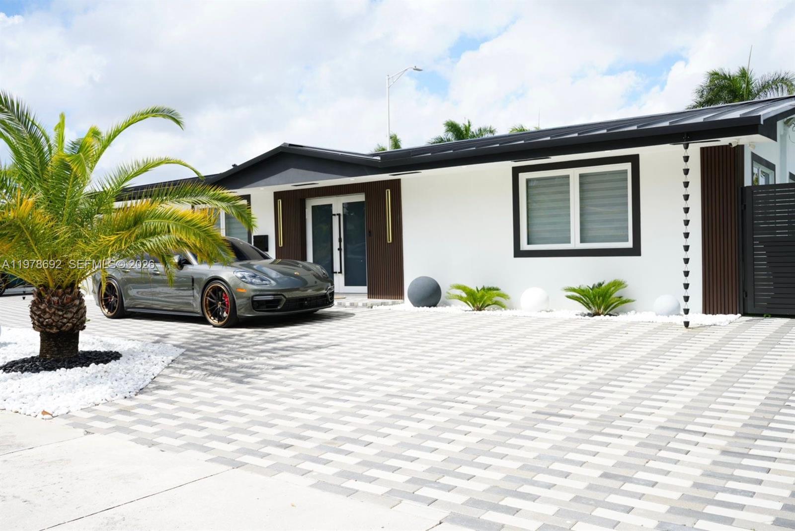 9351 Southwest 88th Terrace Miami, FL 33176 - Photo 2 of 73 a front view of a house with a yard