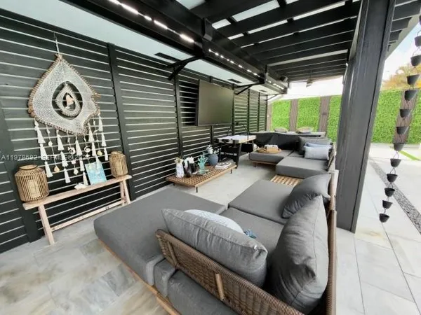 a living room with furniture a fireplace and wooden floor