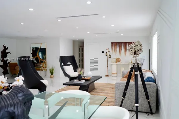 a living room with furniture and wall painting