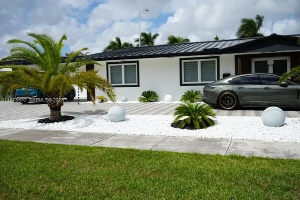 a view of a car parked in front of a house