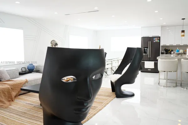 a living room with furniture flowerpot and a flat screen tv