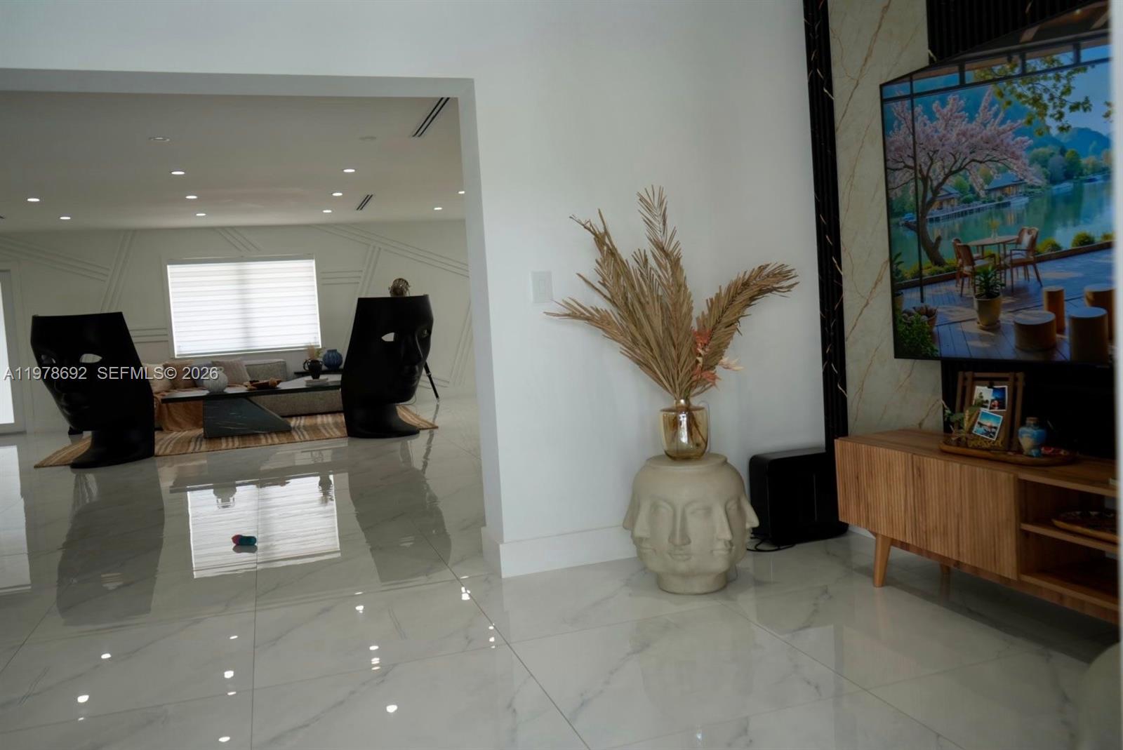 9351 Southwest 88th Terrace Miami, FL 33176 - Photo 34 of 73 a living room with furniture a flat screen tv and a floor to ceiling window
