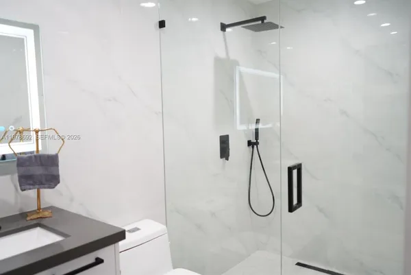 a view of a living room with furniture and a large window