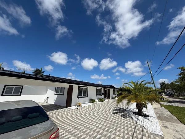 a view of a backyard with sitting area