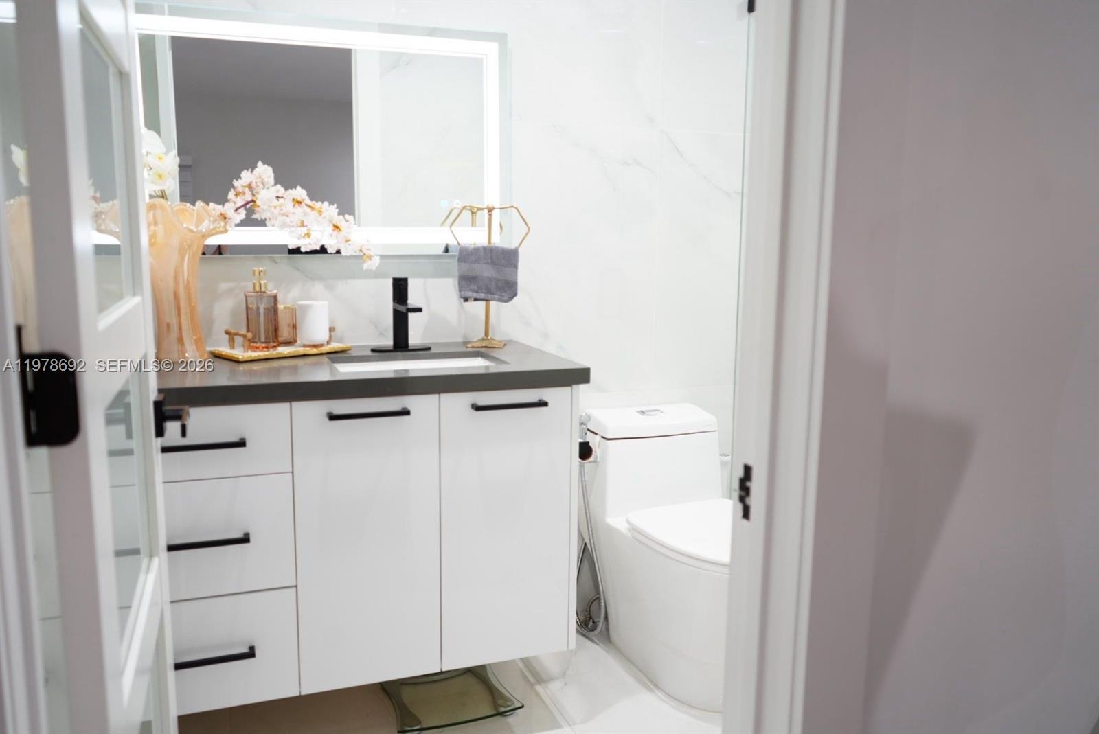 9351 Southwest 88th Terrace Miami, FL 33176 - Photo 52 of 73 a bathroom with a sink and a mirror