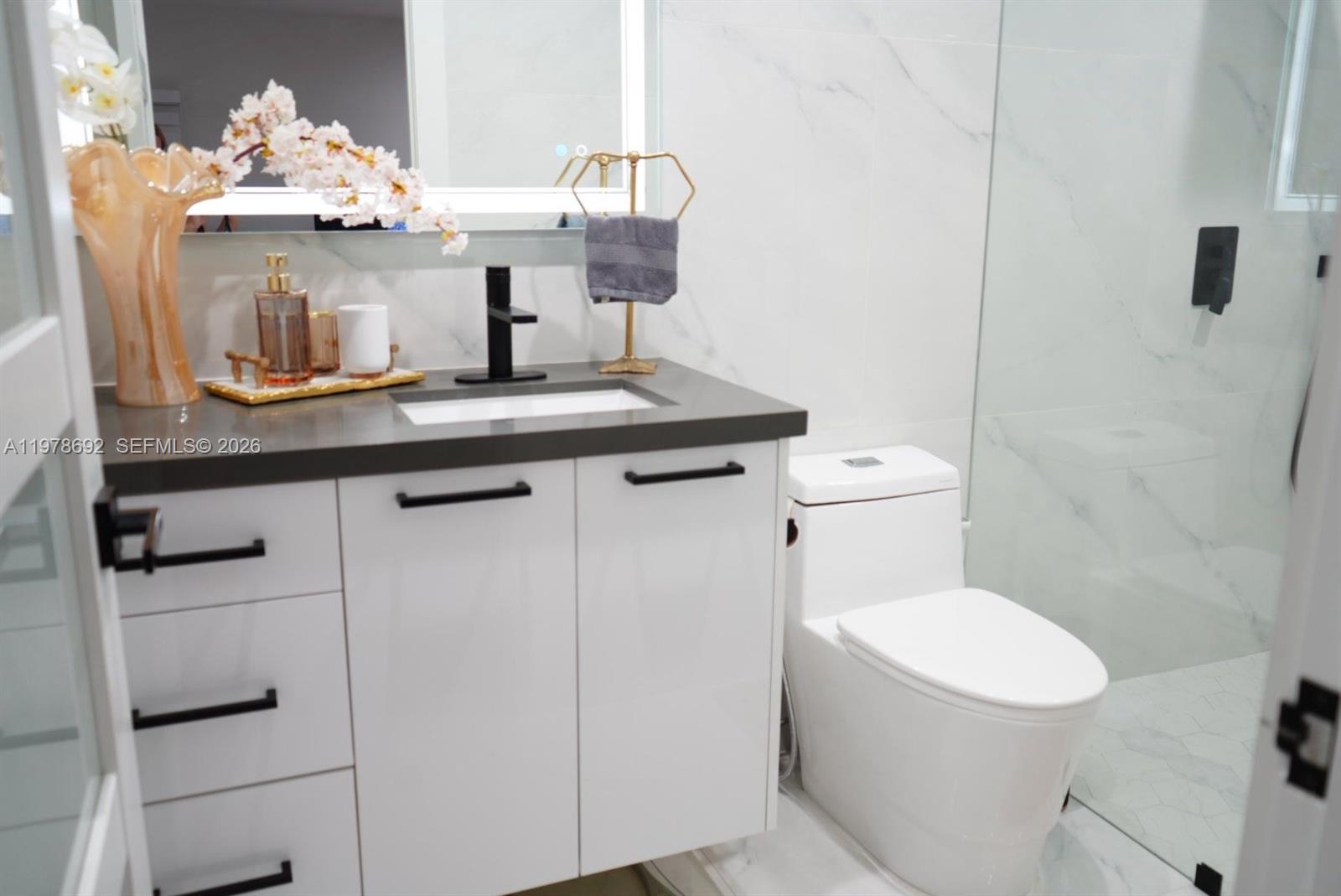 9351 Southwest 88th Terrace Miami, FL 33176 - Photo 54 of 73 a bathroom with a toilet a sink and a mirror