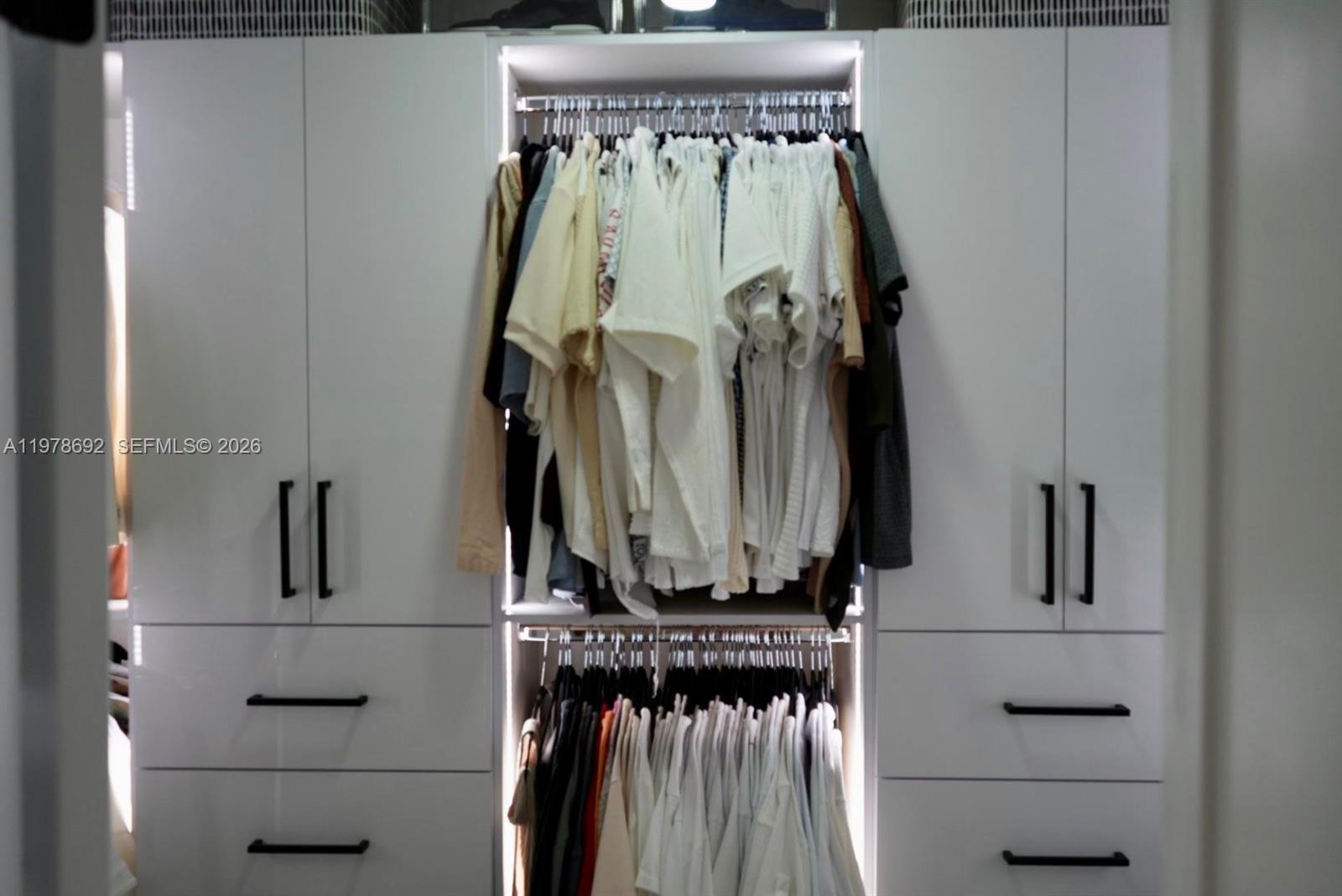 9351 Southwest 88th Terrace Miami, FL 33176 - Photo 58 of 73 a view of walk in closet with clothes and shoes