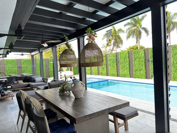 a view of a livingroom with furniture and flat screen tv