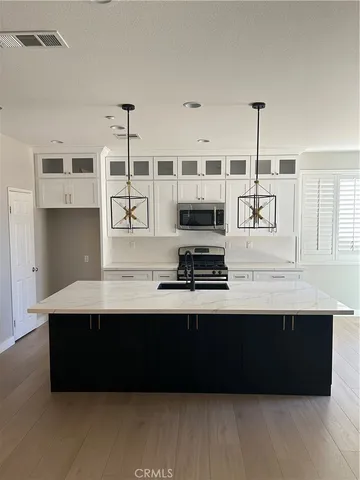 a kitchen with stainless steel appliances a sink a microwave a stove and refrigerator