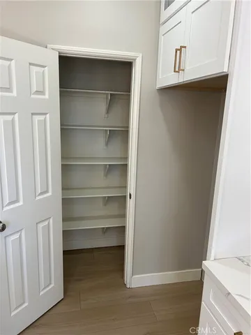 a view of walk in closet with empty racks