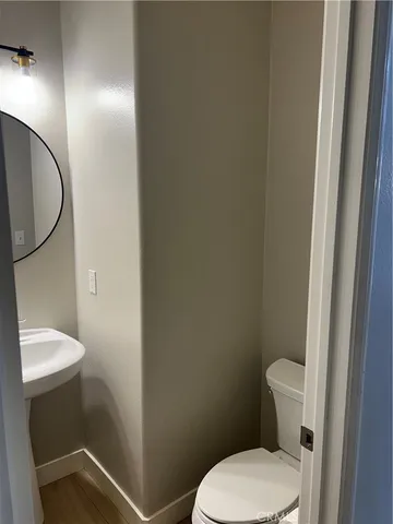 a white toilet sitting next to a shower