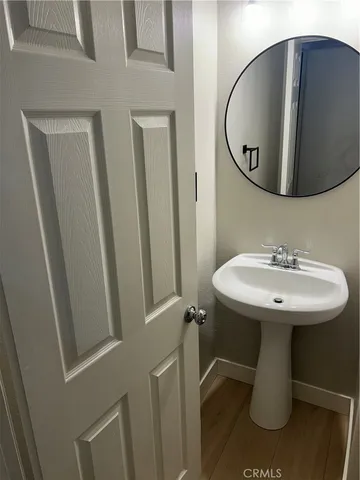 a bathroom with a sink toilet and mirror