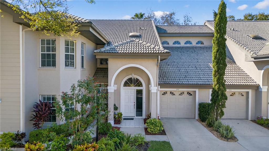 242 Via Perignon, Unit 93 Naples, FL 34119 - Photo 1 of 20 a front view of a house with yellow lighting