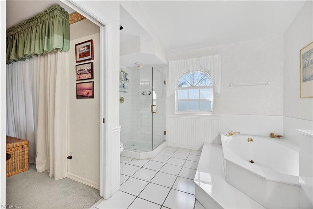 242 Via Perignon, Unit 93 Naples, FL 34119 - Photo 14 of 20 a bathroom with a bathtub and a shower