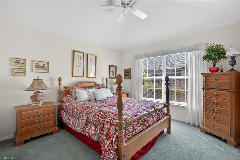 242 Via Perignon, Unit 93 Naples, FL 34119 - Photo 16 of 20 a bedroom with a bed and a dresser