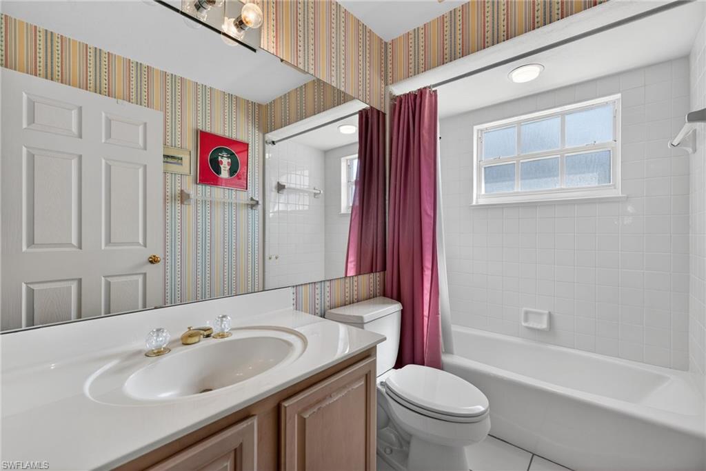242 Via Perignon, Unit 93 Naples, FL 34119 - Photo 17 of 20 a bathroom with a sink a toilet and shower