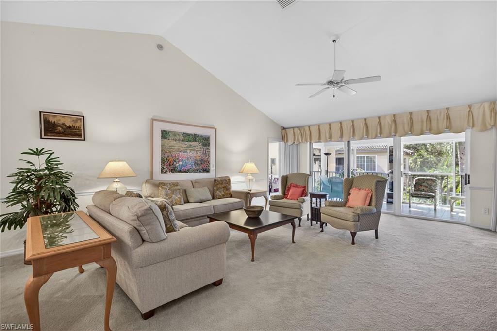 242 Via Perignon, Unit 93 Naples, FL 34119 - Photo 6 of 20 a living room with furniture a chandelier and a window