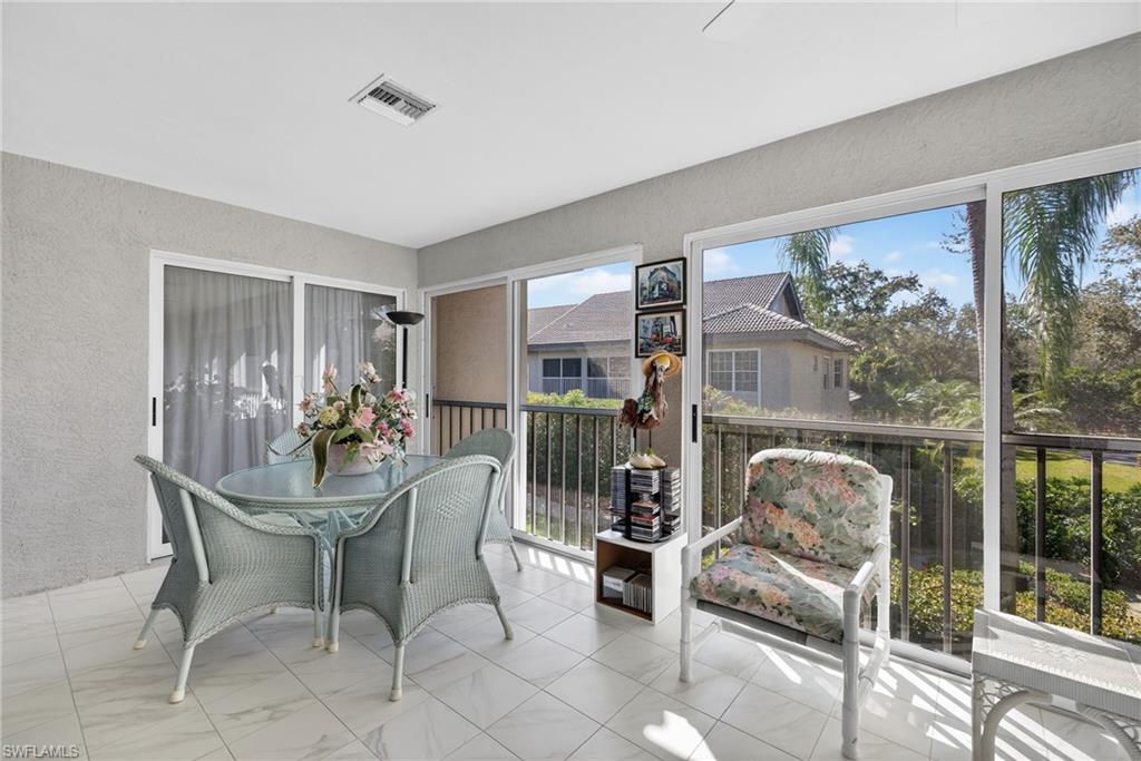 242 Via Perignon, Unit 93 Naples, FL 34119 - Photo 8 of 20 a dining room with furniture and a floor to ceiling window