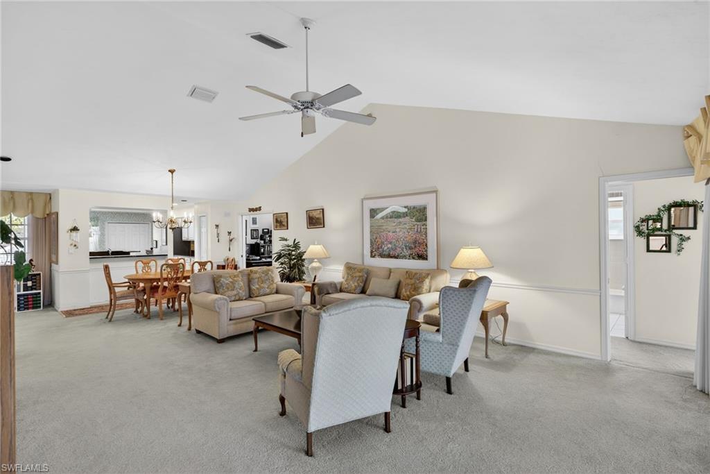 242 Via Perignon, Unit 93 Naples, FL 34119 - Photo 9 of 20 a living room with furniture and a chandelier
