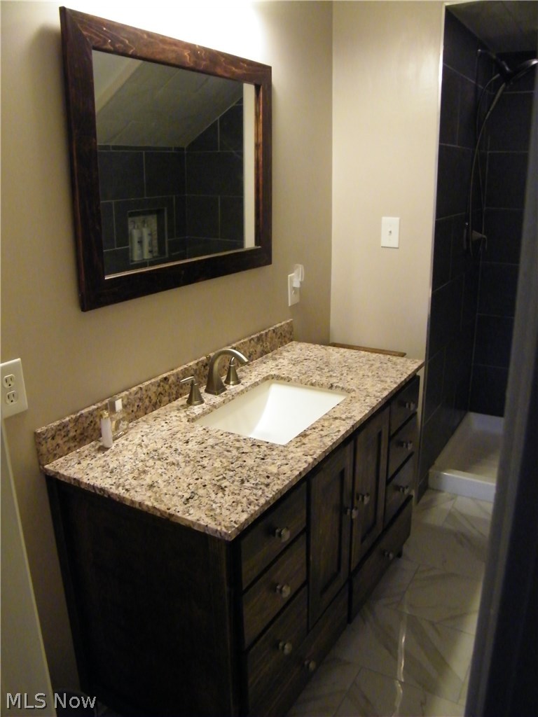 734 Ranney Street Akron, OH 44310 - Photo 20 of 31 Master Bathroom beautiful vanity, mirror, tile flooring, and lighting.