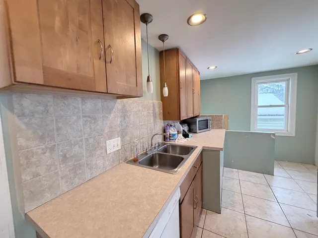 a kitchen with a sink and cabinets