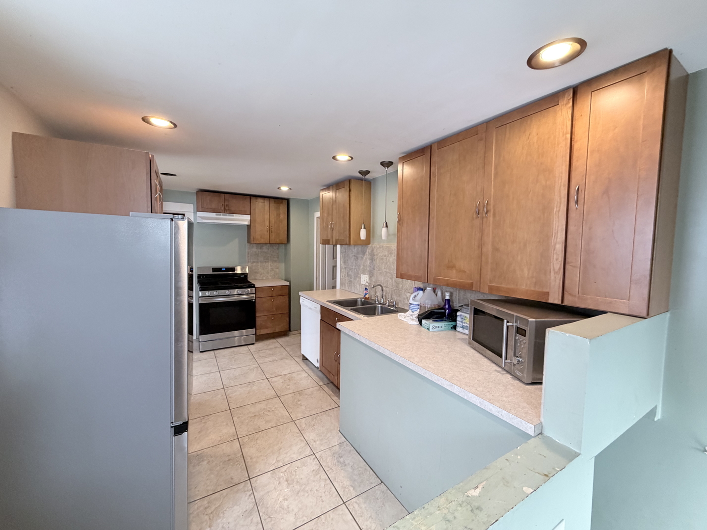 102 East Lincoln Street Pesotum, IL 61863 - Photo 16 of 24 a large kitchen with a large counter top stainless steel appliances and cabinets