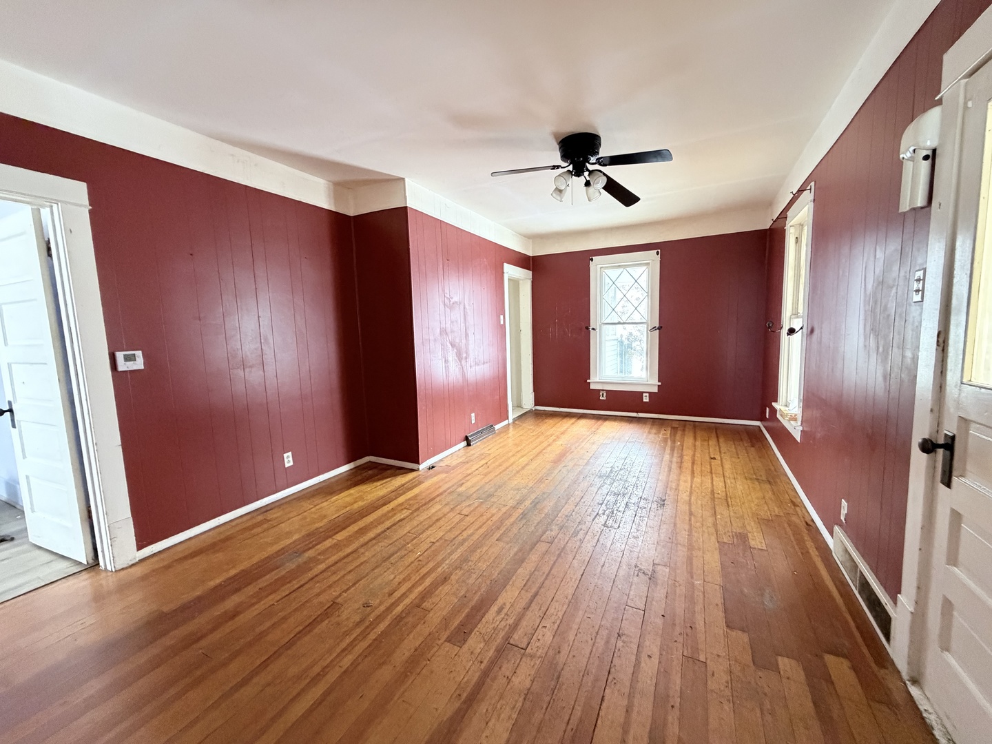 102 East Lincoln Street Pesotum, IL 61863 - Photo 7 of 24 a view of empty room with wooden floor and fan