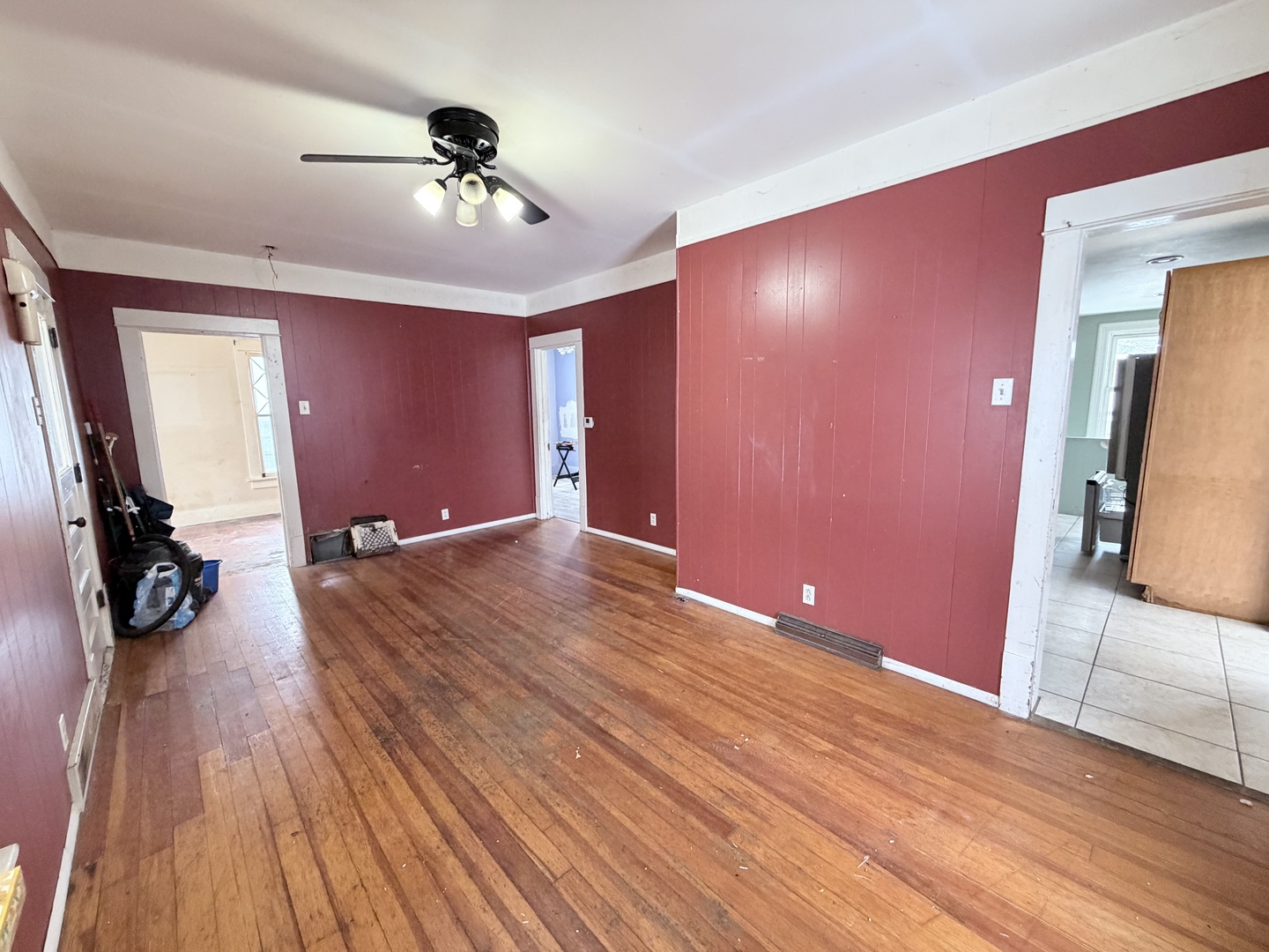 102 East Lincoln Street Pesotum, IL 61863 - Photo 9 of 24 a view of a livingroom with wooden floor and a ceiling fan