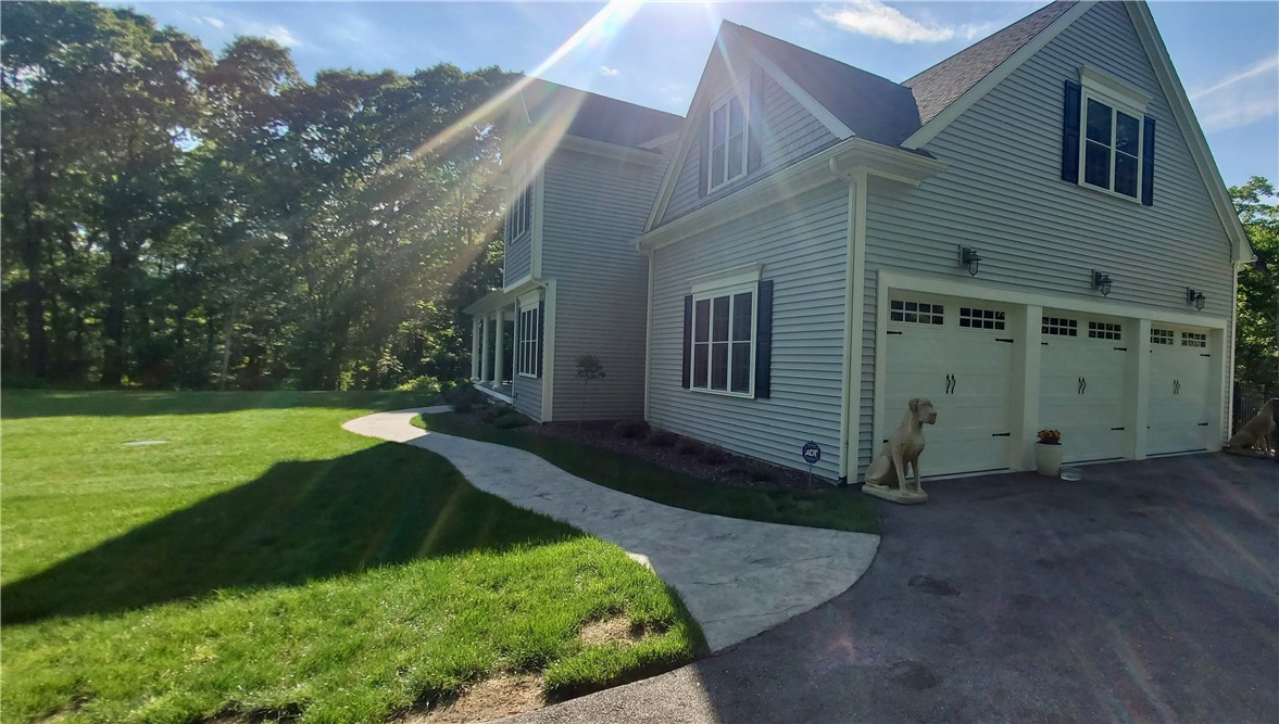 76 Kayla Ricci Way Exeter, RI 02874 - Photo 48 of 49 View of the three car garage and stone walkway to the front entrance to home