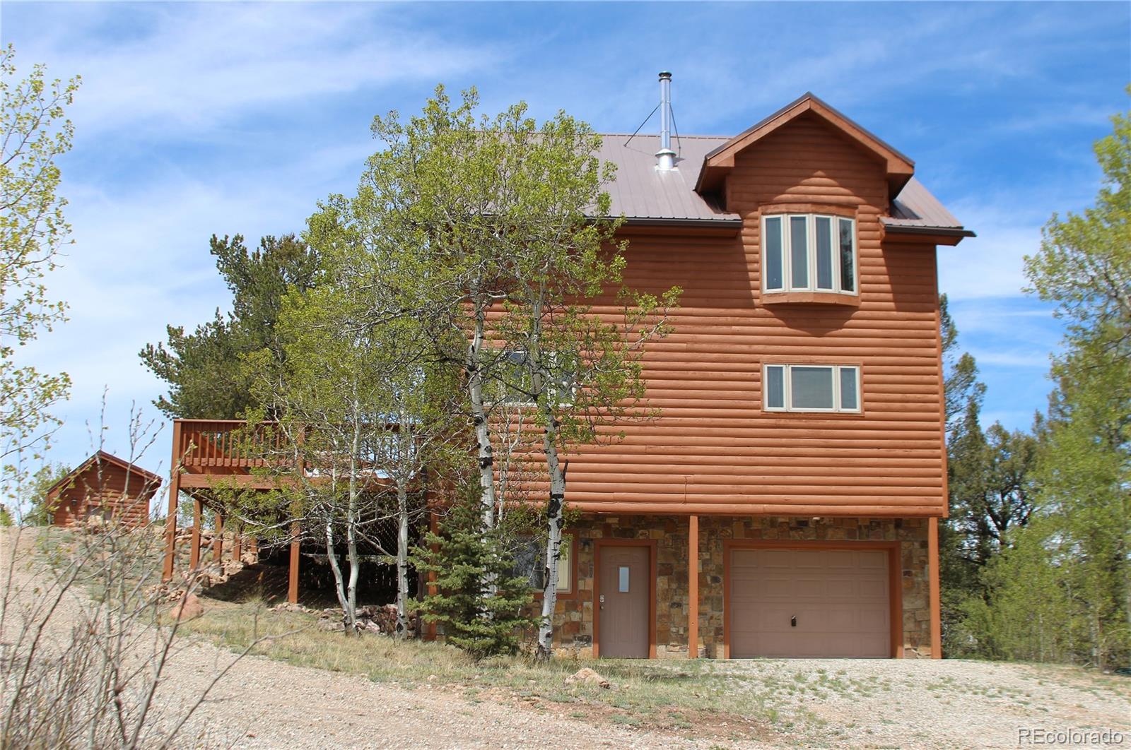 8221 Remington Road Como, CO 80432 - Photo 3 of 49 a front view of a house with a yard