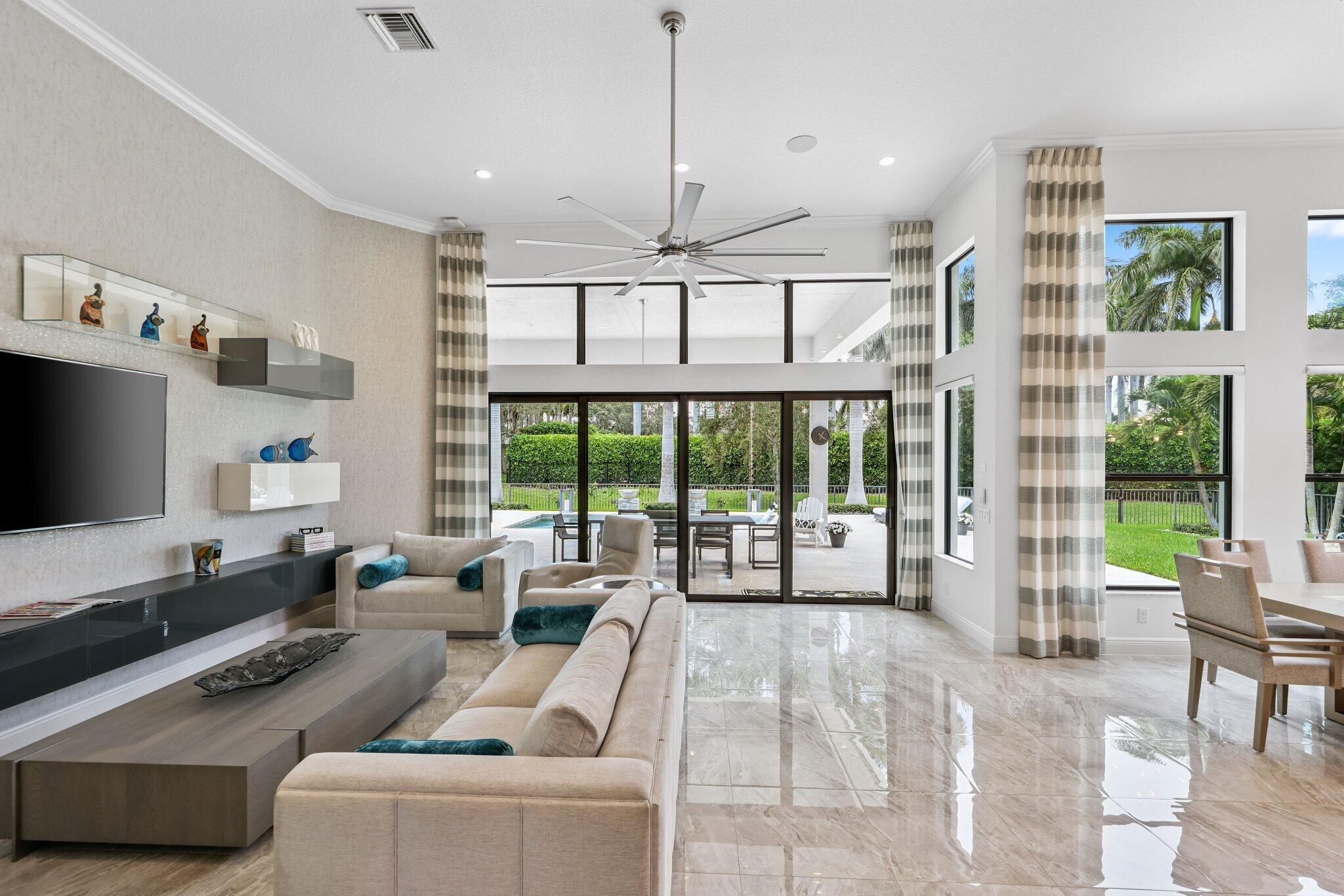 2741 Northwest 70th Boulevard Boca Raton, FL 33496 - Photo 21 of 109 a living room with furniture large window and flat screen tv