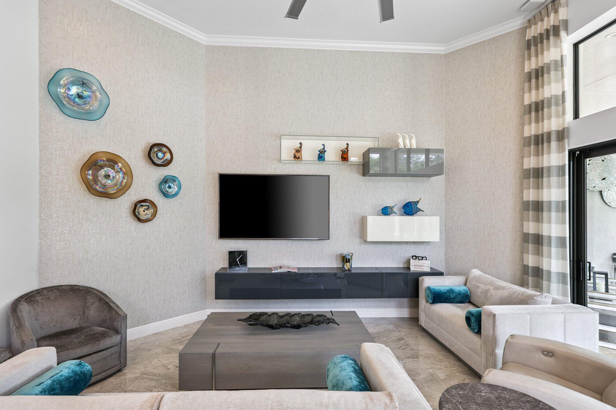 2741 Northwest 70th Boulevard Boca Raton, FL 33496 - Photo 23 of 109 a living room with furniture and a flat screen tv