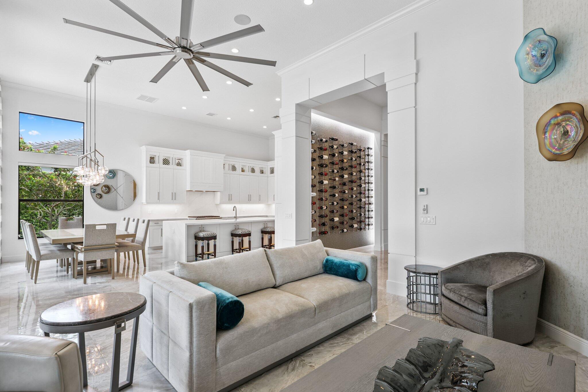 2741 Northwest 70th Boulevard Boca Raton, FL 33496 - Photo 24 of 109 a living room with furniture a clock and a chandelier