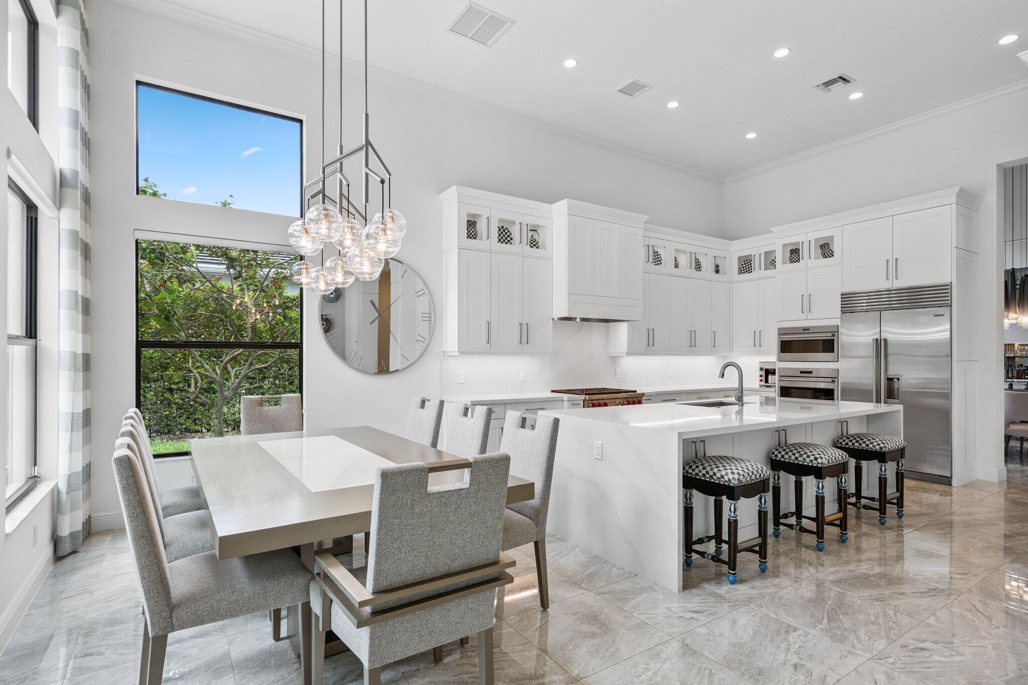 2741 Northwest 70th Boulevard Boca Raton, FL 33496 - Photo 25 of 109 a dining room with furniture a chandelier and kitchen view