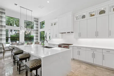 a bathroom with a granite countertop sink a toilet a mirror and shower