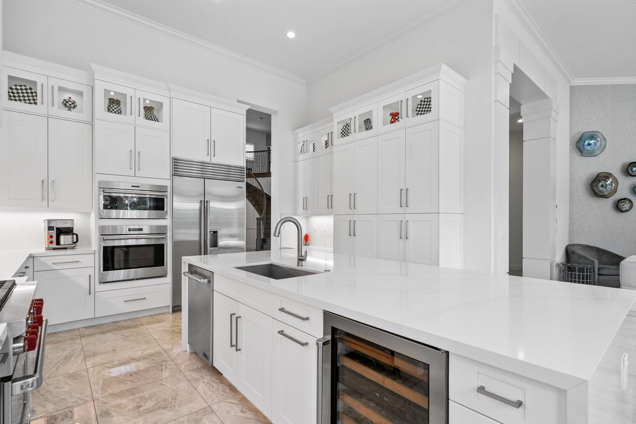 2741 Northwest 70th Boulevard Boca Raton, FL 33496 - Photo 28 of 109 a kitchen with granite countertop a sink stove and refrigerator