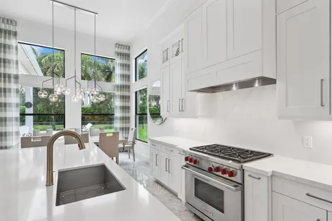 a bedroom with a bed and a lamp on dresser