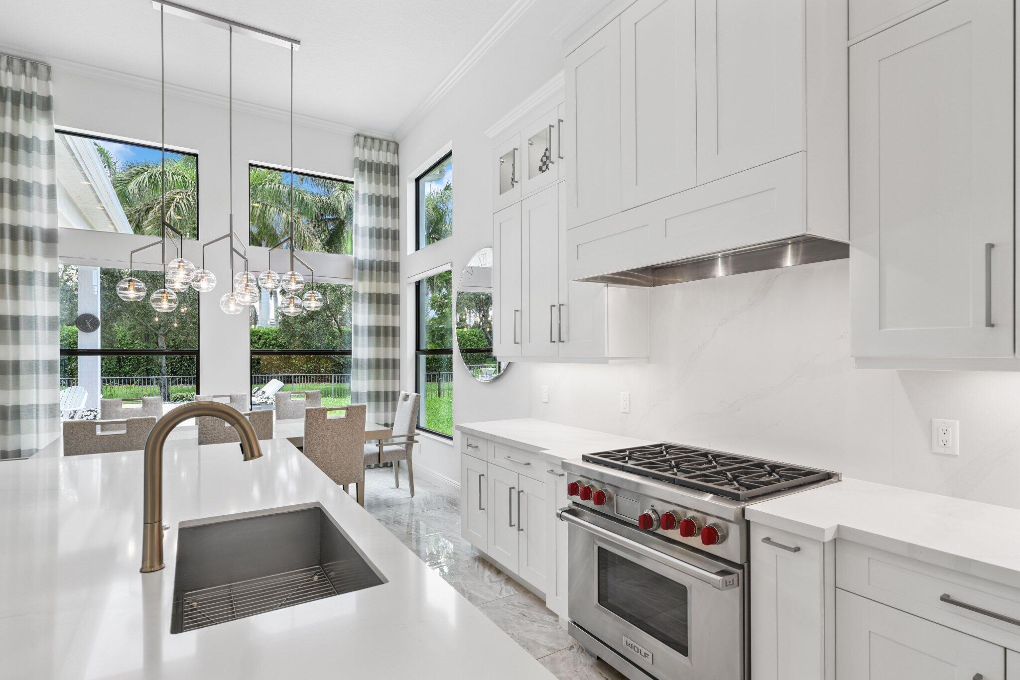 2741 Northwest 70th Boulevard Boca Raton, FL 33496 - Photo 32 of 109 a kitchen with stainless steel appliances granite countertop a stove and a sink