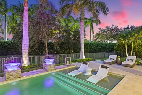 a view of a patio with table and chairs under an umbrella