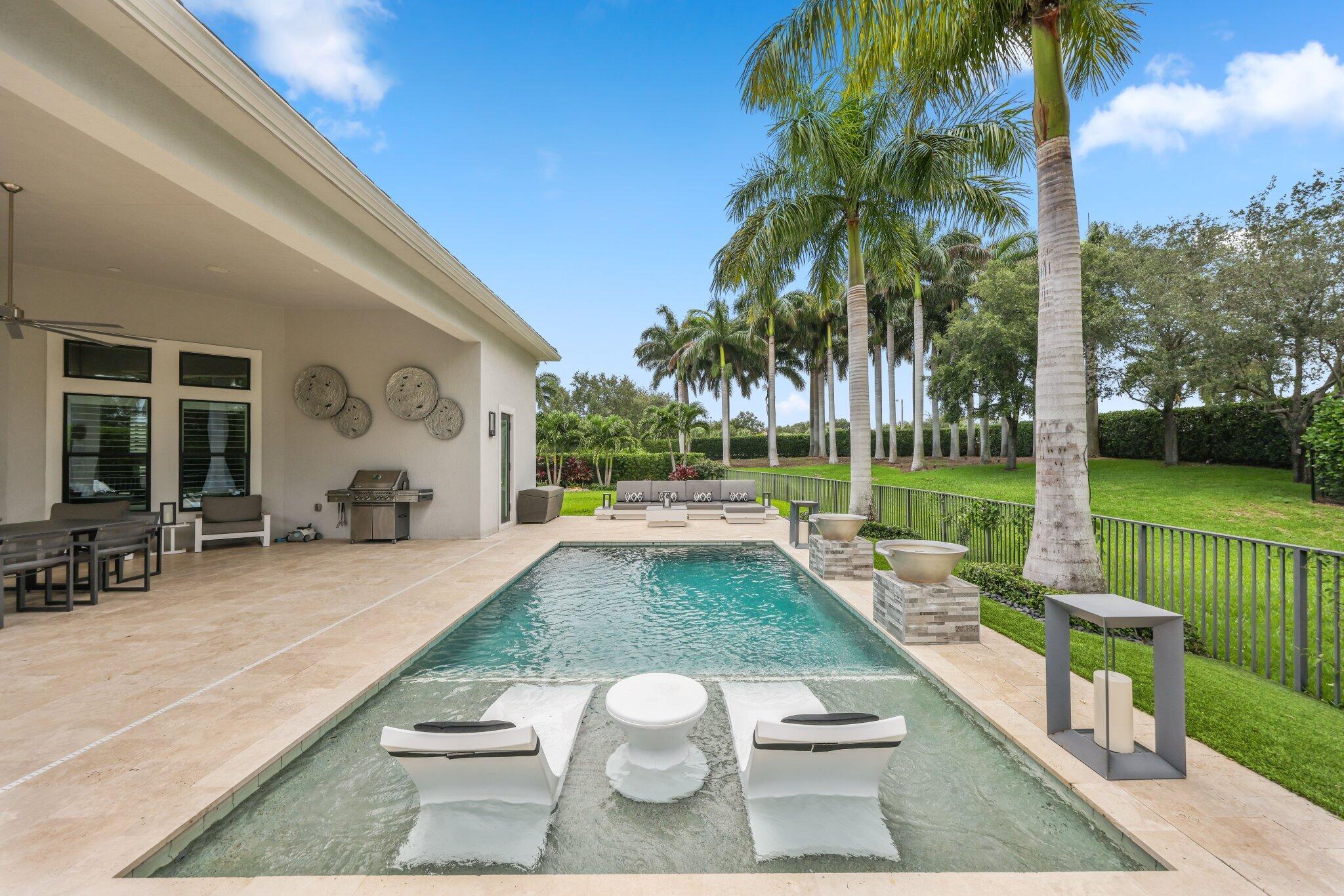 2741 Northwest 70th Boulevard Boca Raton, FL 33496 - Photo 39 of 109 a view of swimming pool with a patio and a garden