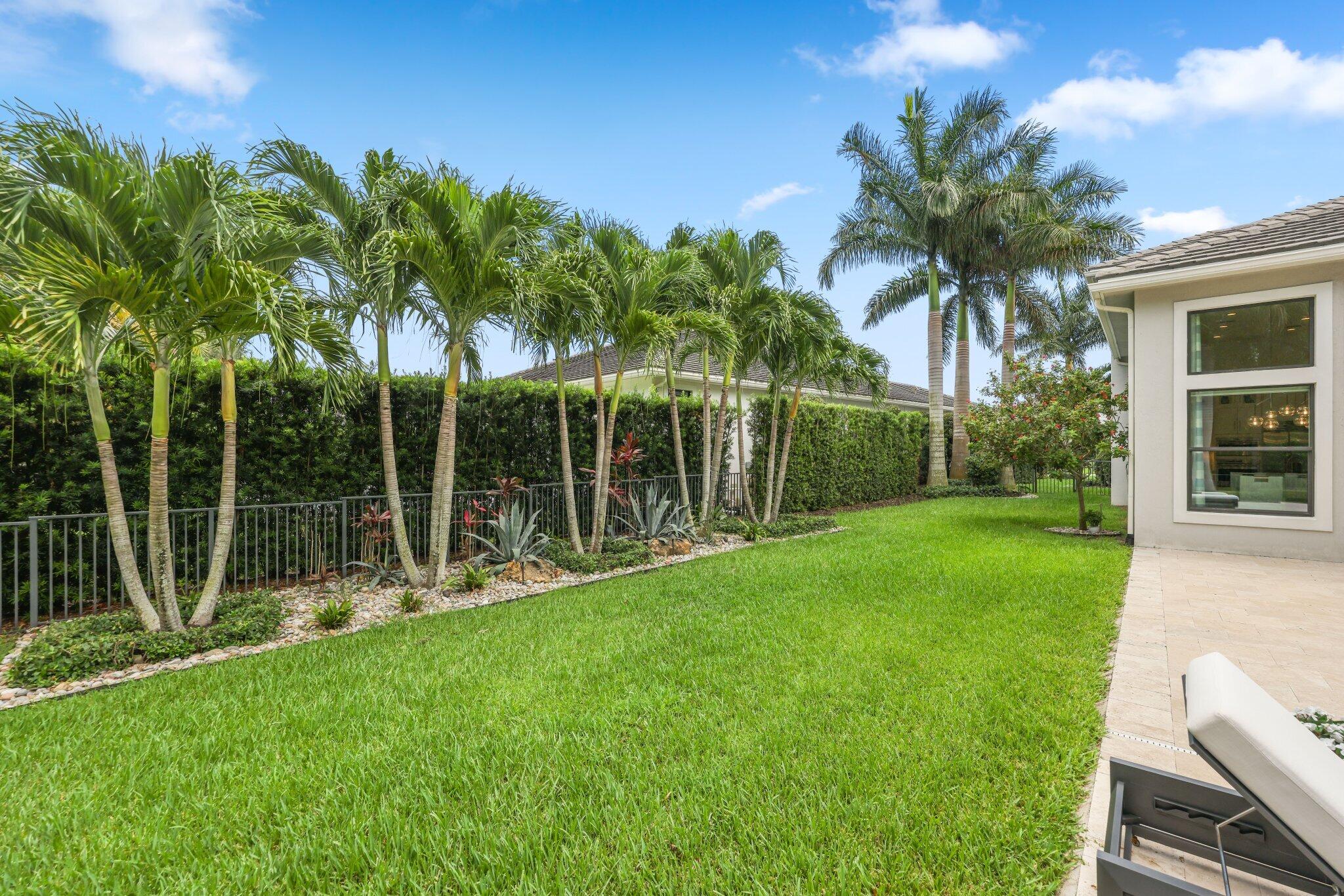 2741 Northwest 70th Boulevard Boca Raton, FL 33496 - Photo 44 of 109 a view of a backyard with a slide trees and plants