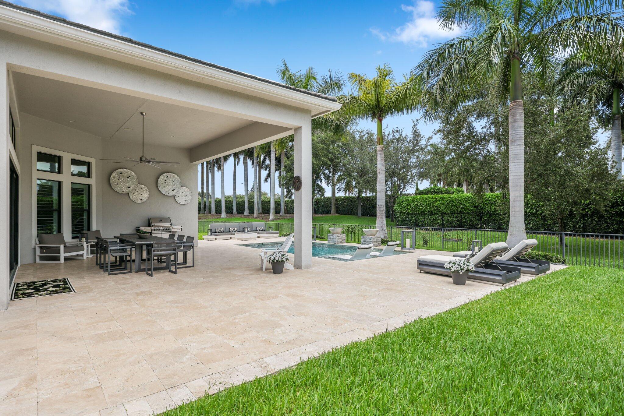 2741 Northwest 70th Boulevard Boca Raton, FL 33496 - Photo 46 of 109 a view of a house with backyard sitting area and garden