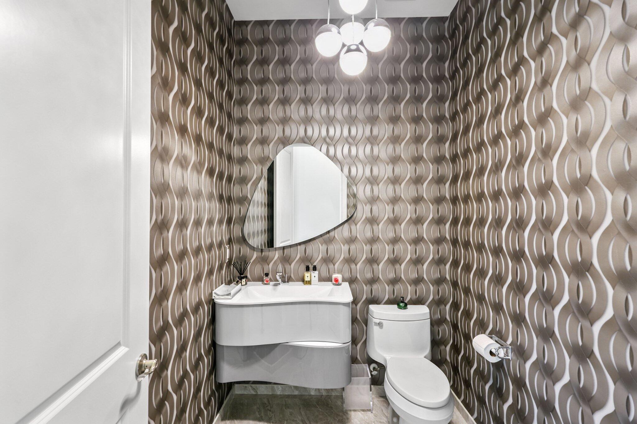 2741 Northwest 70th Boulevard Boca Raton, FL 33496 - Photo 65 of 109 a bathroom with a toilet a sink and mirror