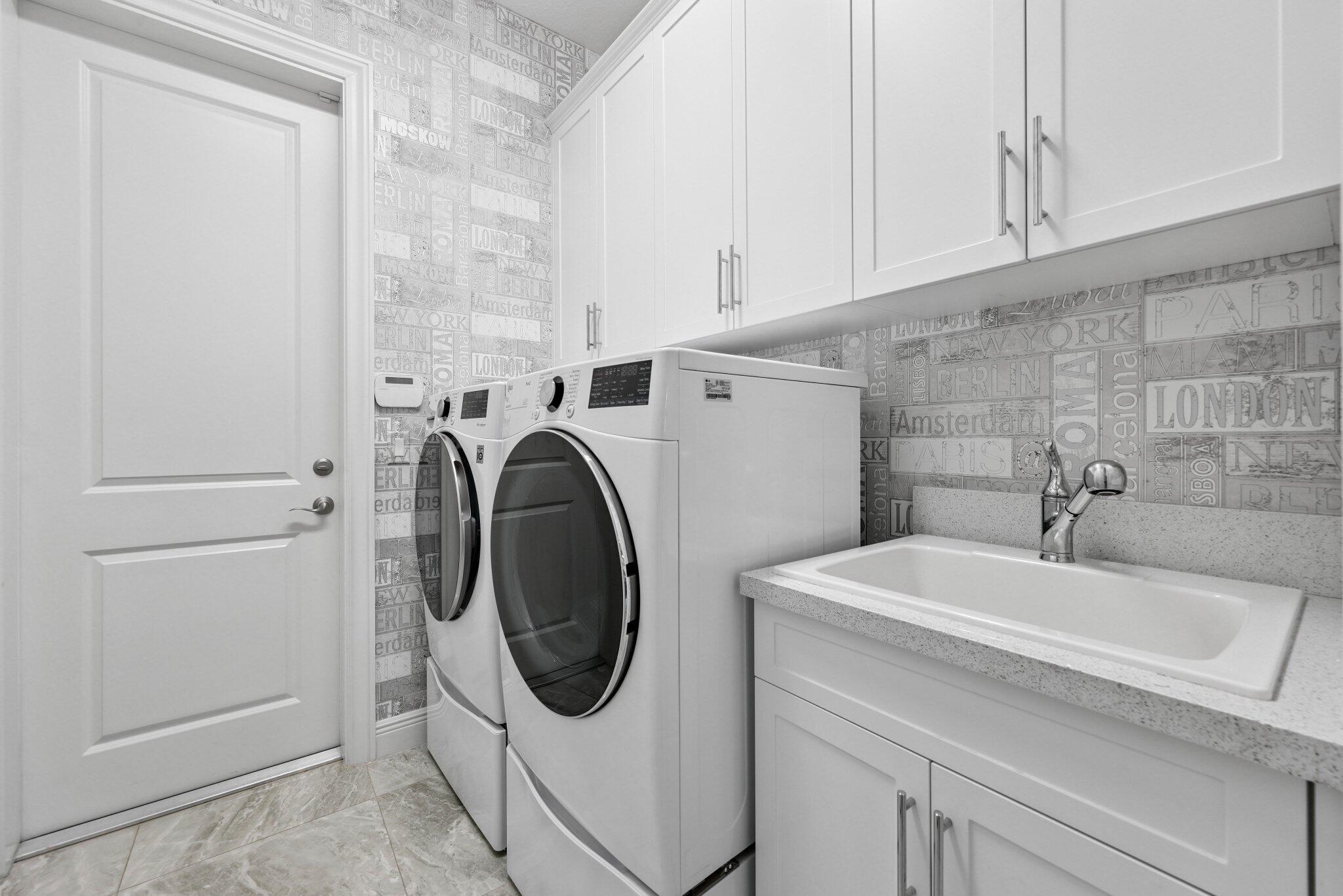 2741 Northwest 70th Boulevard Boca Raton, FL 33496 - Photo 66 of 109 a utility room with dryer and washer
