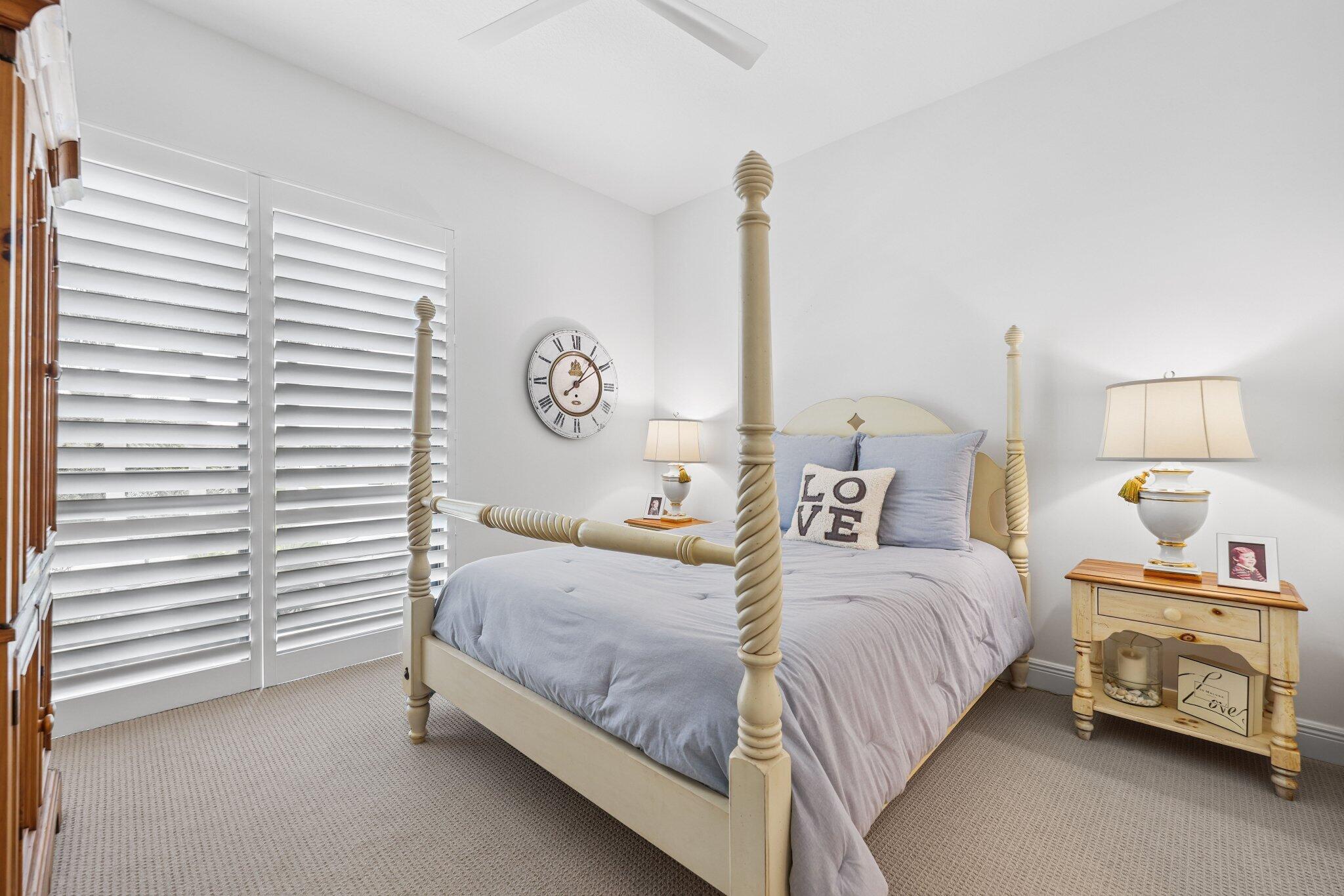 2741 Northwest 70th Boulevard Boca Raton, FL 33496 - Photo 70 of 109 a bedroom with a bed and a lamp on dresser